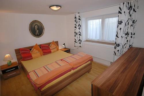 a bedroom with a large bed and a window at Příjemné místo pro odpočinek s bazeném in Radovesice