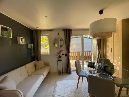 a living room with a couch and a table at Camping Le Mont César in Gouvieux