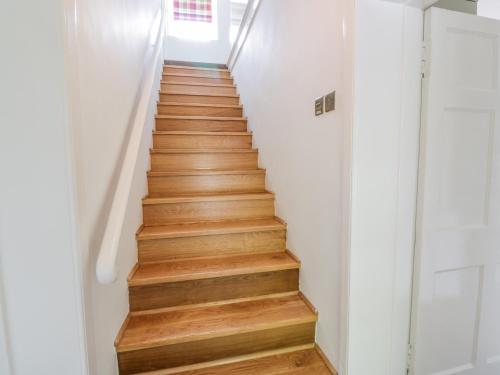 a staircase in a house with wooden floors at Garden House - Culzean Castle in Maybole