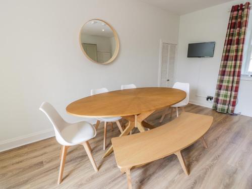 a dining room table with white chairs and a mirror at Garden House - Culzean Castle in Maybole