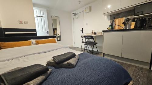 a bedroom with a large bed with towels on it at Beautiful Studios - Chapel Market in London