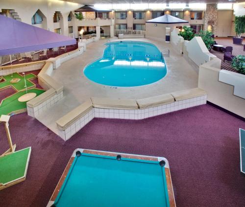 an overhead view of a large pool in a hotel at Ramada by Wyndham Midtown Grand Island in Grand Island