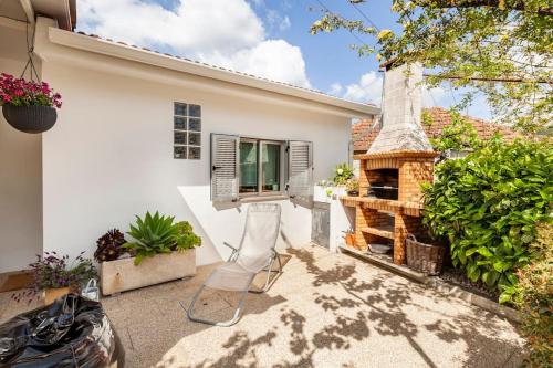 a backyard with a fireplace and a house at Casa do Fontanário in Penafiel