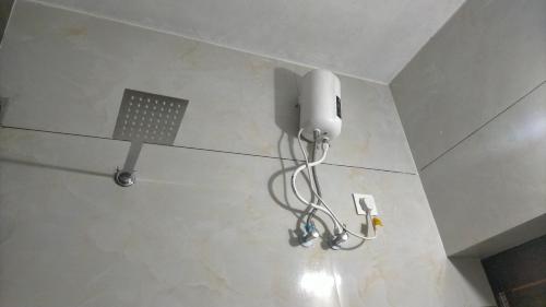 a light hanging from the ceiling of a room at Signature by Rayhan in Vālpārai