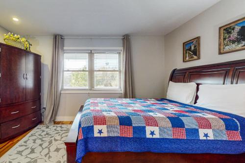 a bedroom with a bed and a dresser and a window at Smoky Mountain Lake Retreat in Dandridge