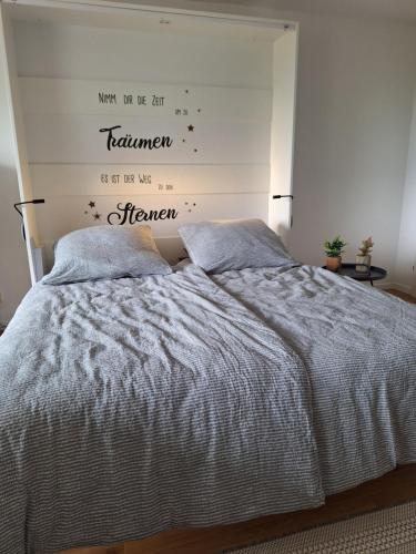 a bedroom with a bed with two pillows at Ferienwohnung Allgäuerle 1605 Ski in Ski out an der Skipiste mit Hallenbad Sauna und Tiefgarage in Missen-Wilhams