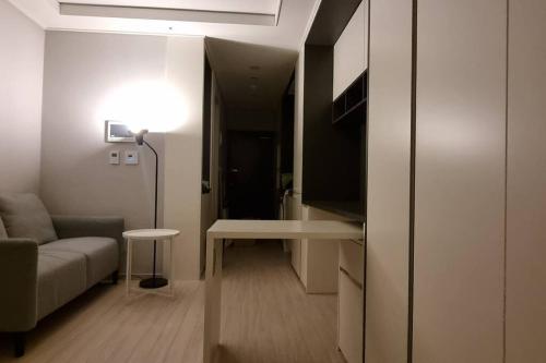 a living room with a couch and a table and a lamp at W House r077 in Gimpo