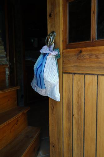 a bag is hanging on a door knob at Moinhos do Alecrim in Penacova