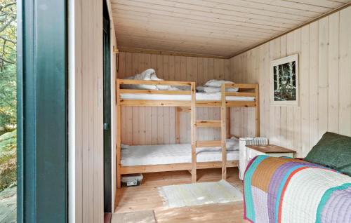 a room with two bunk beds in a cabin at Cozy Home In Stege With Wifi in Stege
