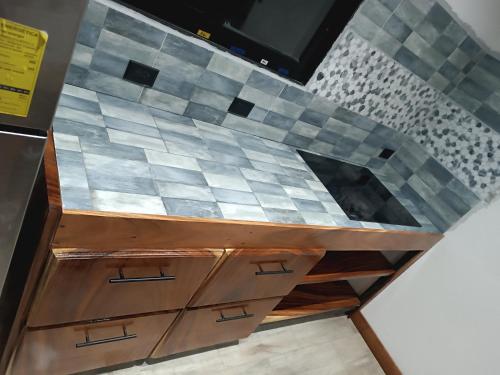 a kitchen with a counter top with a mosaic tile wall at Athila Ecolove in Monteverde Costa Rica