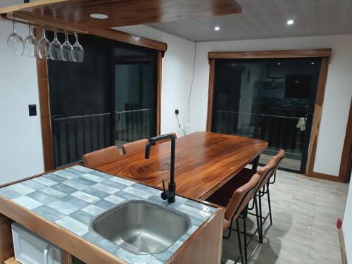 a kitchen with a sink and a wooden counter top at Athila Ecolove in Monteverde Costa Rica