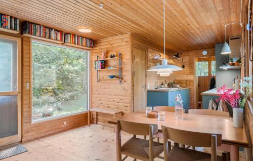 a dining room with a table and a large window at Cozy Home In Stege With Wifi in Stege