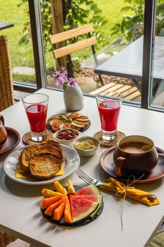 a table topped with plates of food and drinks at Hotel Elvezia in Cannobio