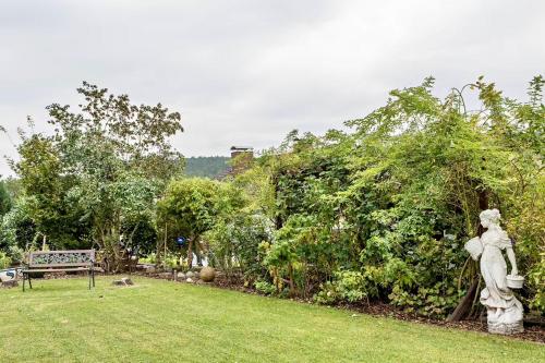 a statue of a woman standing in a garden at Ferienwohnung Wasserturmblick in Bebra