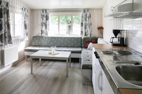 a living room with a couch and a table at Kvibergs Stugor - Cottages in Gothenburg