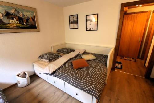 a bedroom with a bed with a laptop on it at Petit havre de paix! in Les Collons