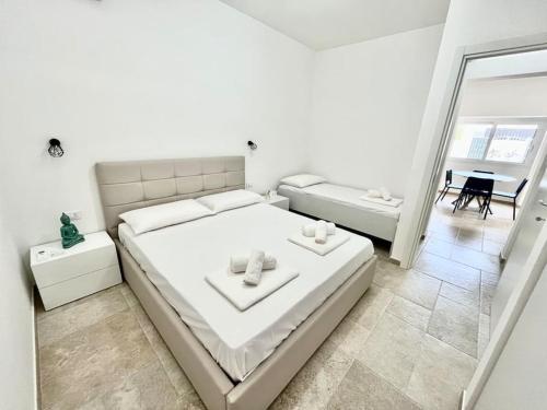 Ένα ή περισσότερα κρεβάτια σε δωμάτιο στο Il Villino Porto Cesareo - Alloggio con posto auto