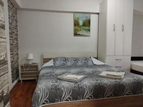 a bedroom with a bed with two towels on it at Vila Katerina Dojran in Star Dojran