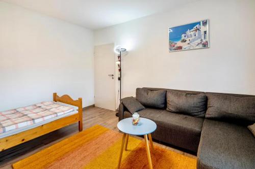 a living room with a couch and a table at Ferienwohnung Wasserturmblick in Bebra