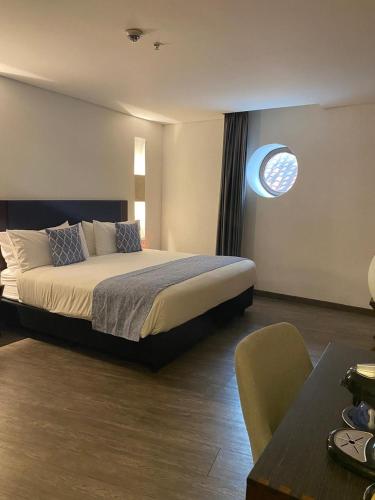 a hotel room with a bed and a table at Hotel Santa Catalina By OxoHotel in Cartagena de Indias