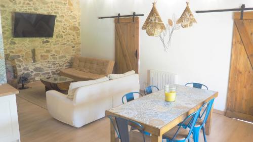 a living room with a table and a couch at Apartamentos Muralla Sacra in Sober