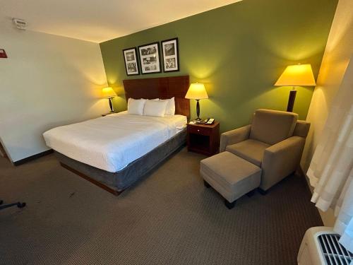 a hotel room with a bed and a chair at Sleep Inn & Suites Manchester near Arnold AFB in Manchester