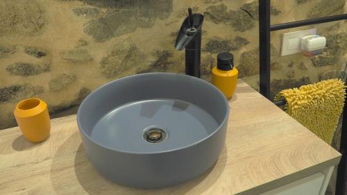 a blue sink sitting on a counter in a bathroom at Apartamentos Muralla Sacra in Sober