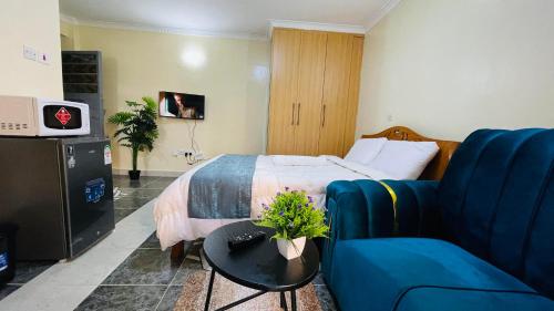 a hotel room with a bed and a couch at Well Furnished Studio Apartment at Kamakis Opposite Quickmart in Ruiru