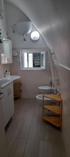 a bathroom with a sink and a tub and a window at Casa Nannina in Matera