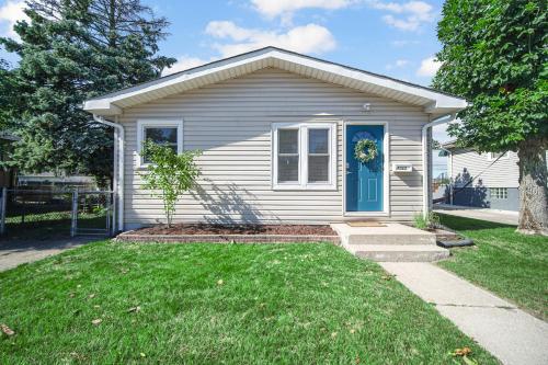 a small white house with a blue door at Cozy Private Room in Hammond, IN - 2 in Hammond