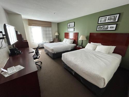 a hotel room with two beds and a desk at Sleep Inn & Suites Manchester near Arnold AFB in Manchester