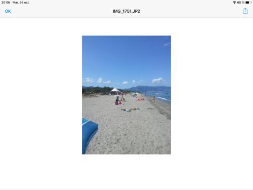 a screenshot of a beach with people on the sand at Maison à la plage.7 couchages in Borgo