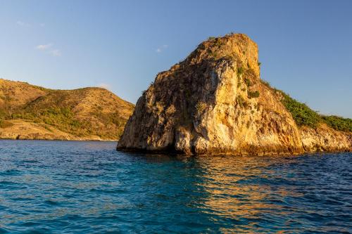 a large rock in the middle of the water at Monasterio del Viento in Bahia Maracaibo