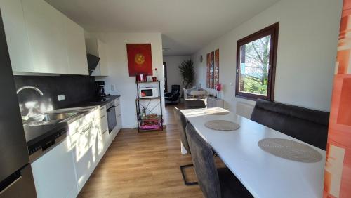 a kitchen with a white counter and a kitchen island at Cottage Alpenblick in Gramastetten