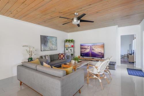 a living room with a couch and a ceiling fan at Charming House with Private Pool n Coral Gable in Miami