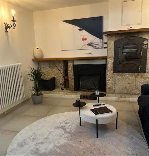 a living room with a table and a fireplace at LOFT SUL FIUME center home in Ascoli Piceno
