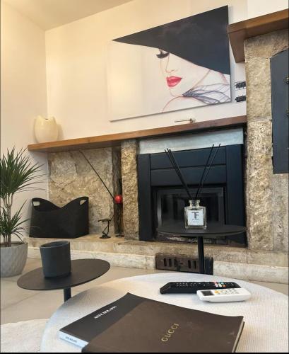 a living room with a fireplace with a tv on a wall at LOFT SUL FIUME center home in Ascoli Piceno