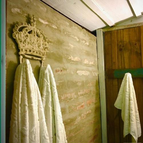 a bathroom with white towels hanging on a wall at Reserva Pedra da Mata in Pelotas