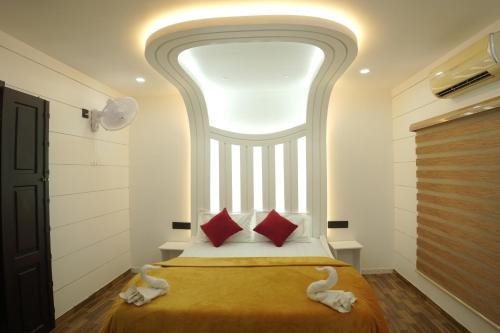 a bedroom with a bed with a large window at Vaishnav Tours in Alleppey