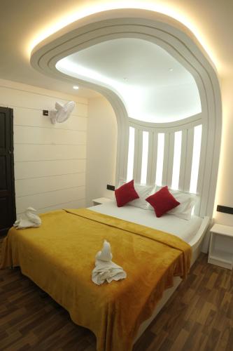 a bedroom with a large bed with a large window at Vaishnav Tours in Alleppey