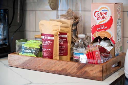 a wooden tray with food items on a counter at Pastel Paradise - Adorable Covington Apartment in Covington