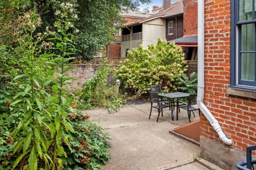 a patio with a table and chairs in a yard at Pastel Paradise - Adorable Covington Apartment in Covington