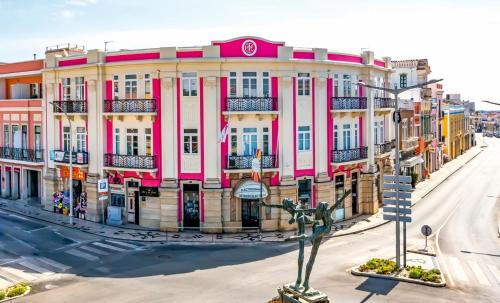 a pink and white building on a city street at Arts by Loulé - Alojamento de Charme in Loulé