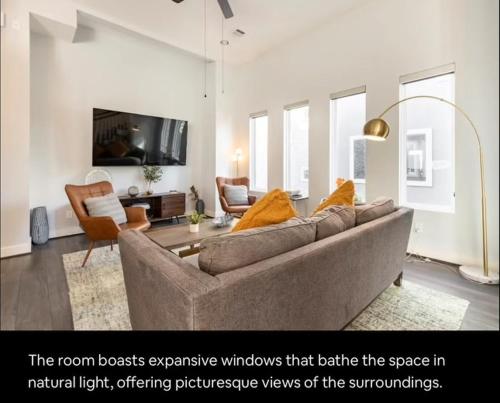 a living room with a couch and a tv at Sophisticated Urban Retreat with Skyline Views home in Houston