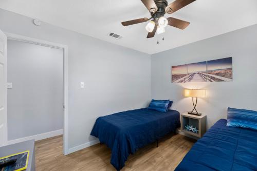 a bedroom with two beds and a ceiling fan at R & R's Reel Paradise 5 minutes to the harbour and 11 miles to the Beach! in Aransas Pass