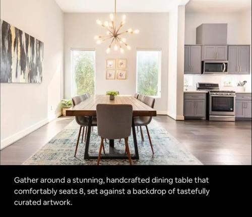 a dining room with a table and chairs in a kitchen at Sophisticated Urban Retreat with Skyline Views home in Houston