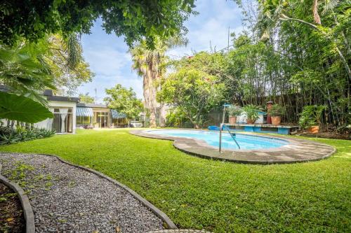 an outdoor swimming pool in a yard with trees at Family-Friendly Oasis with Pool in Cuernavaca in Cuernavaca