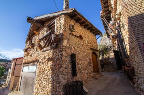a stone building with a cross on the side of it at La casita de ucero in Ucero