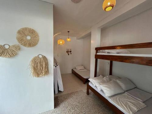 a bedroom with a bunk bed and a bathroom at Caleboat Beach Resort in Kalooñgan