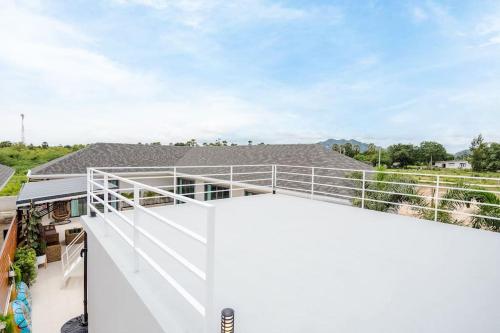 a balcony with white railing on a house at come home pool villa cha-am in Phetchaburi